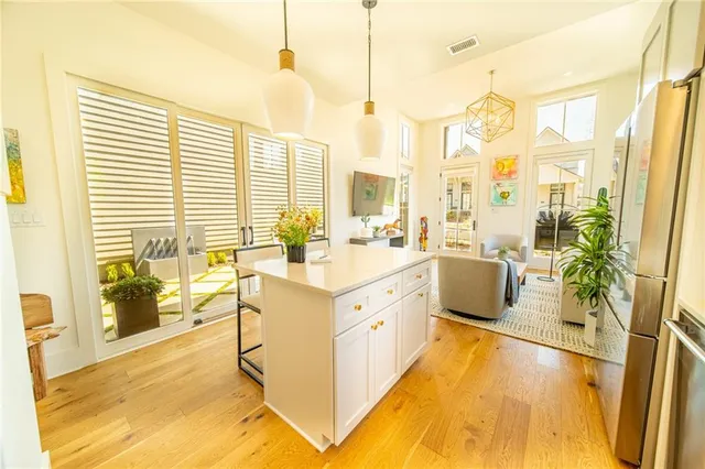 a large white kitchen with a large window