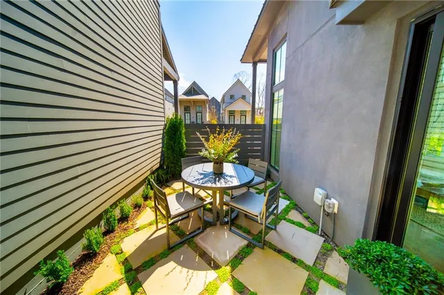 a backyard of a house with table and chairs