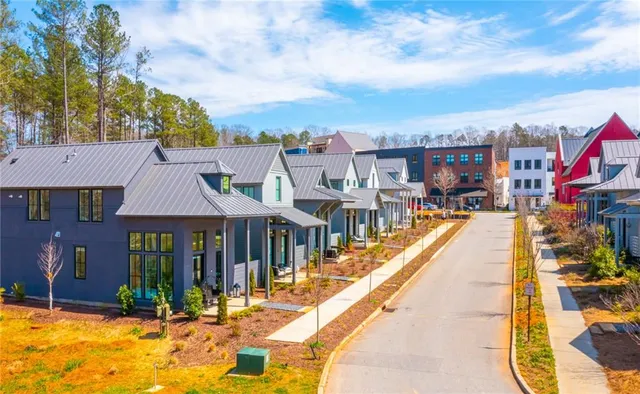 a view of residential houses with yard and swimming pool