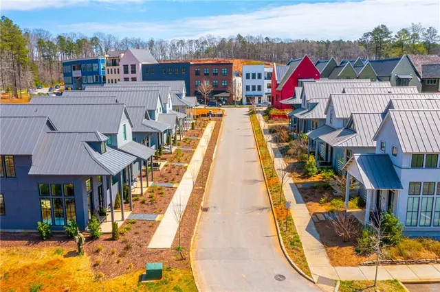 an aerial view of a houses with a swimming pool