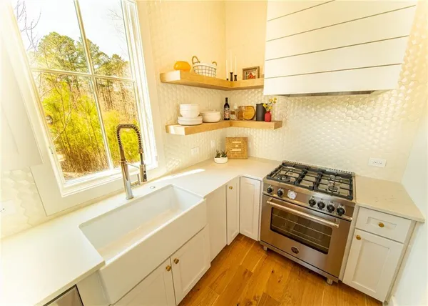 a kitchen with a stove a sink and a refrigerator