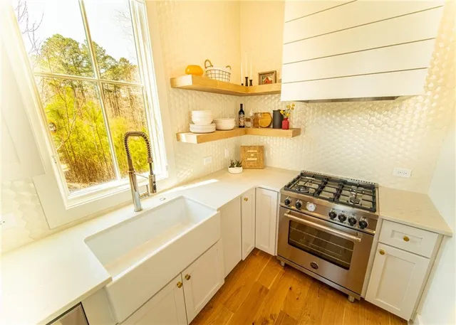 a kitchen with a stove a sink and a refrigerator