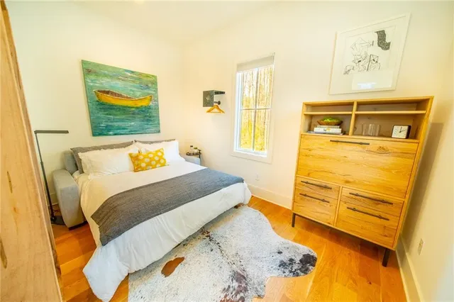 a bedroom with a bed and wooden floor