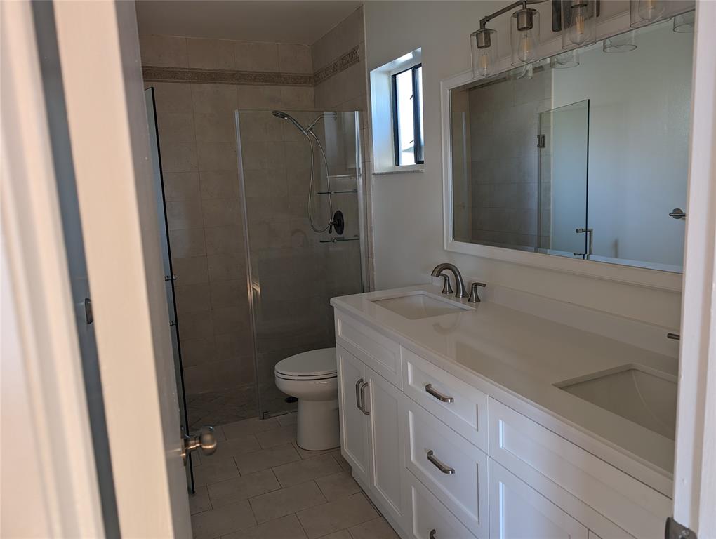 707 Southeast 3rd Avenue Dania Beach, FL 33004 - Photo 11 of 26 a bathroom with a sink a toilet and shower