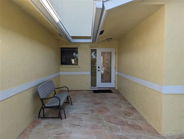 a view of a hallway with seating area