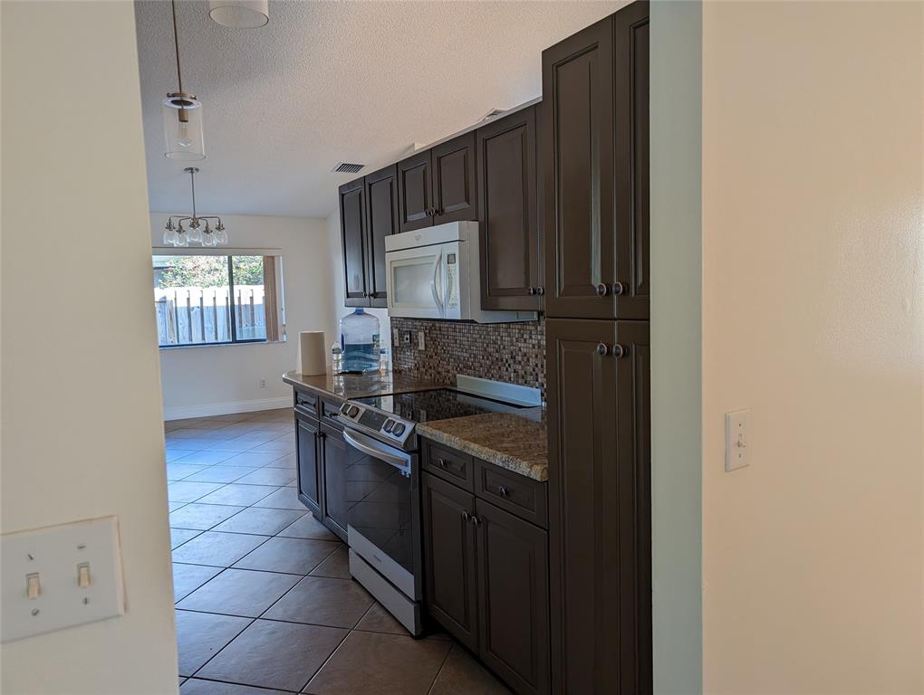 707 Southeast 3rd Avenue Dania Beach, FL 33004 - Photo 6 of 26 a kitchen with stainless steel appliances granite countertop a stove and a sink