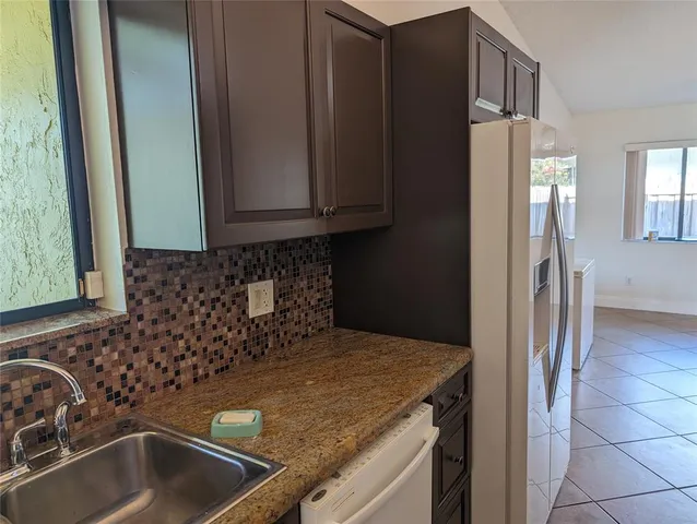 a kitchen with a sink and refrigerator