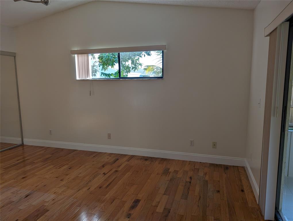 707 Southeast 3rd Avenue Dania Beach, FL 33004 - Photo 10 of 26 an empty room with wooden floor and windows
