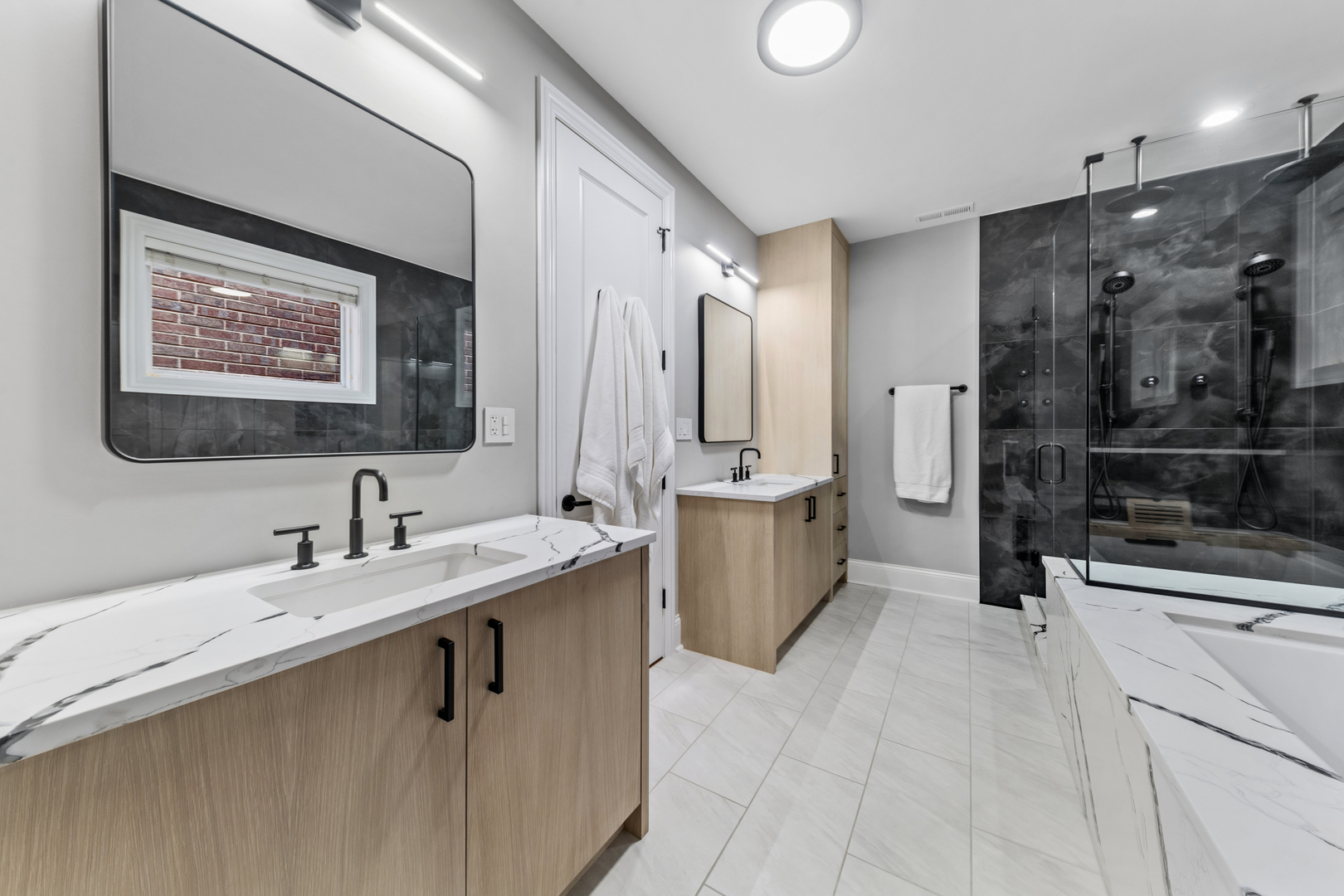 1460 West Byron Street Chicago, IL 60613 - Photo 13 of 33 a bathroom with a sink a mirror a bathtub and shower