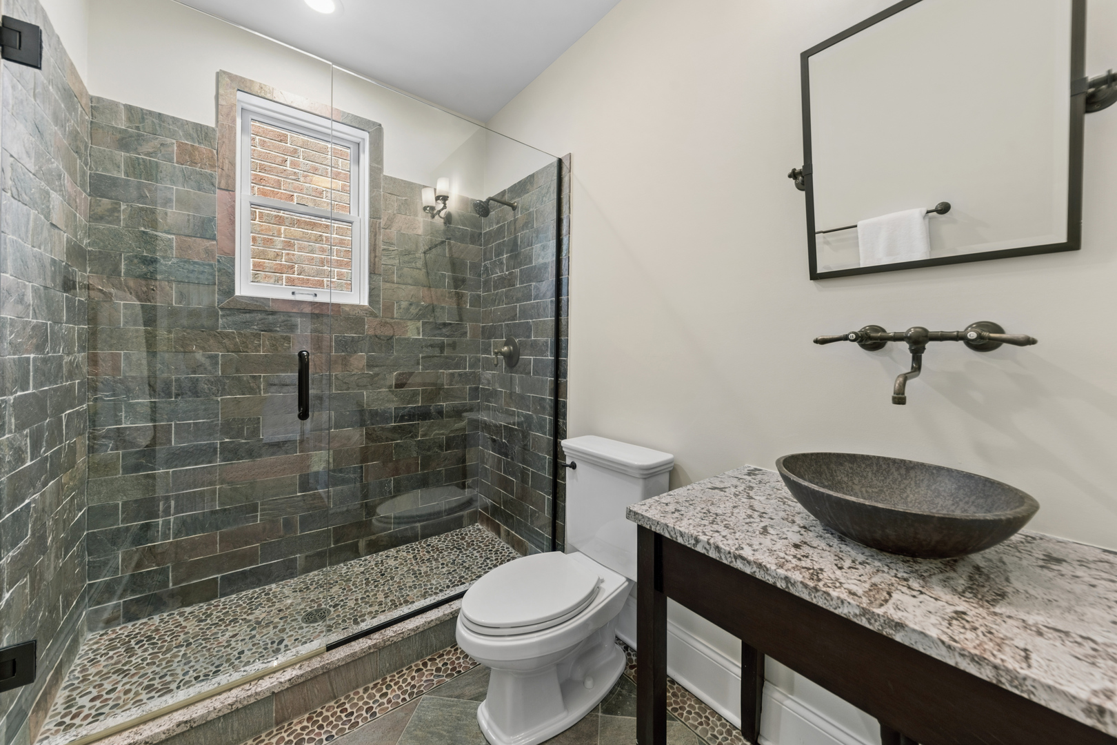 1460 West Byron Street Chicago, IL 60613 - Photo 26 of 33 a bathroom with a granite countertop sink a toilet and shower
