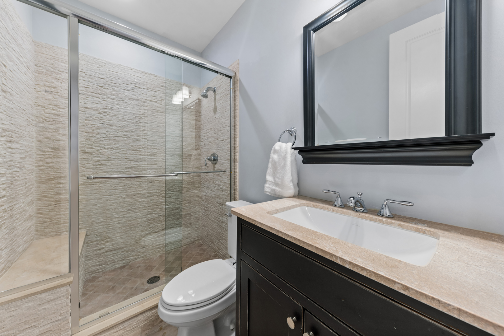 1460 West Byron Street Chicago, IL 60613 - Photo 30 of 33 a bathroom with a granite countertop sink toilet a mirror and shower