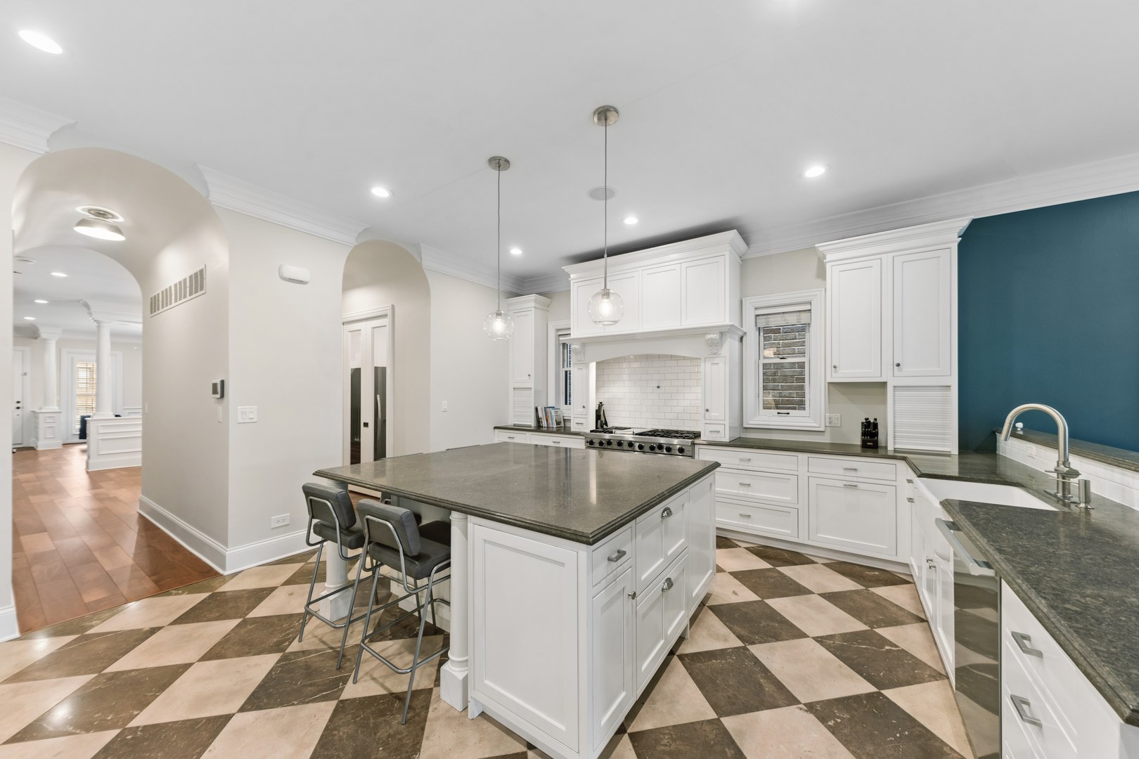 1460 West Byron Street Chicago, IL 60613 - Photo 7 of 33 a kitchen with a sink a counter and chairs