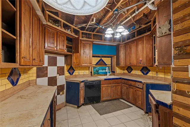 a view of a kitchen with kitchen island a stove a sink and a microwave