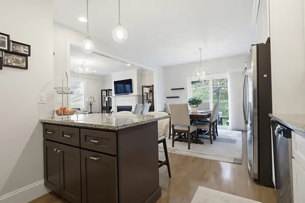 a kitchen with granite countertop a sink dining table and chairs