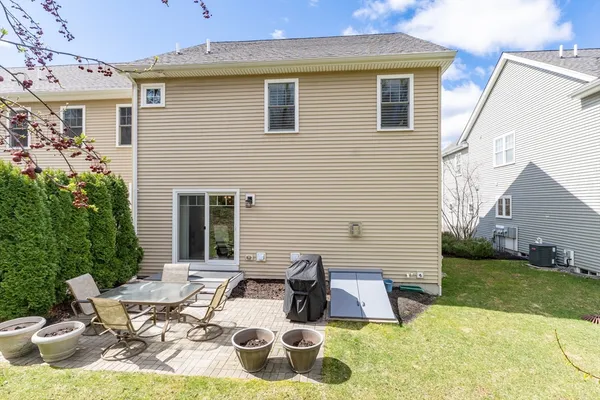 a view of backyard of house with seating space