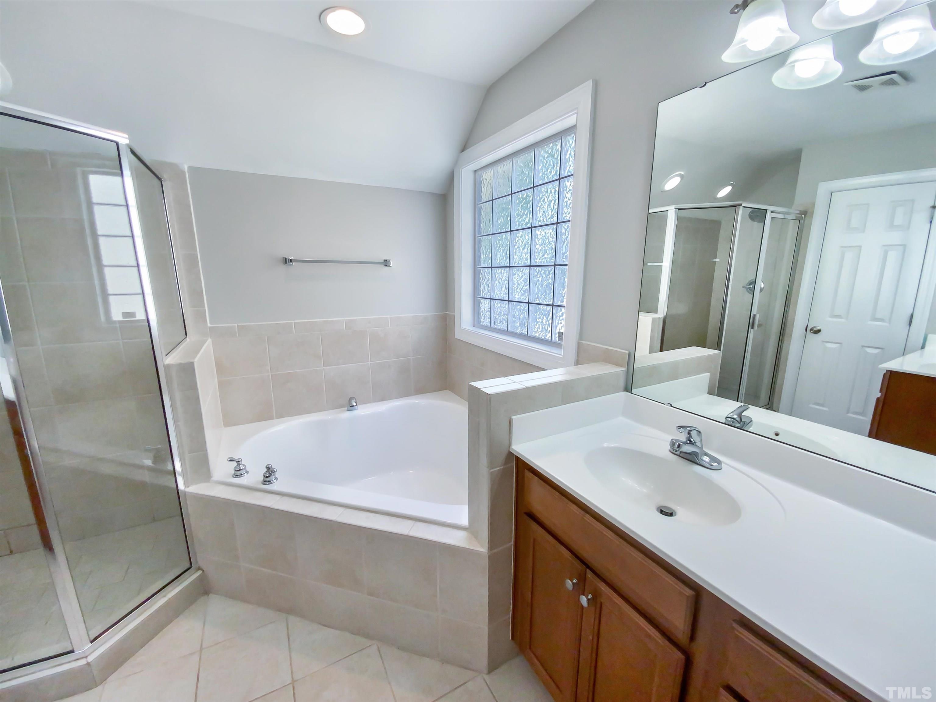 2106 Cloud Cover Lane Raleigh, NC 27614 - Photo 6 of 21 a bathroom with a tub sink and mirror