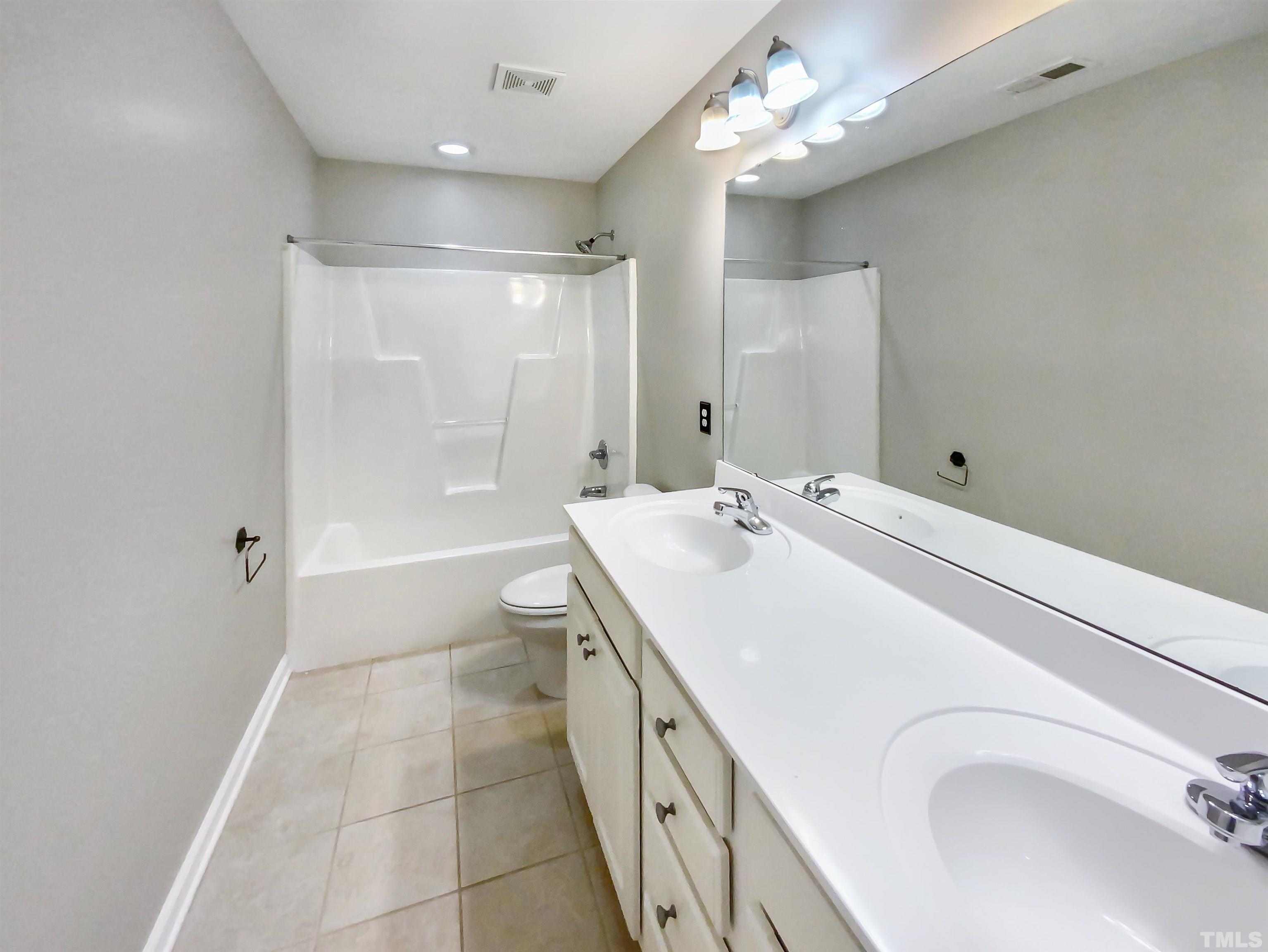2106 Cloud Cover Lane Raleigh, NC 27614 - Photo 10 of 21 a spacious bathroom with a double vanity sink a toilet and shower