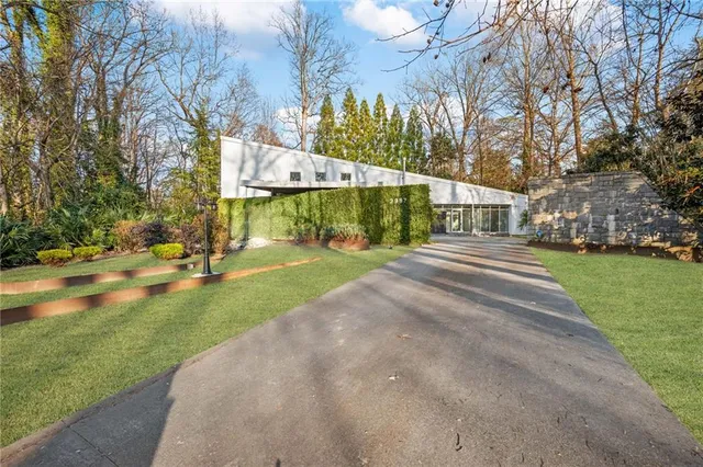 a view of yard with swimming pool and green space