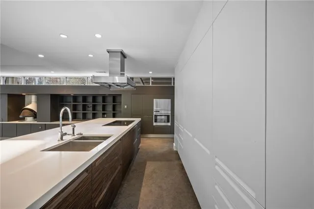 a kitchen with a sink and view of living room