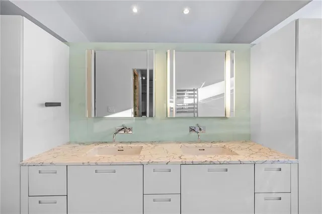a bathroom with a granite countertop sink and a mirror