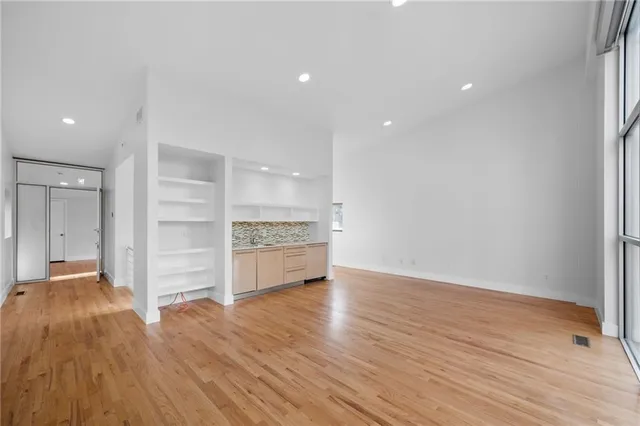 a view of a room with wooden floor and window