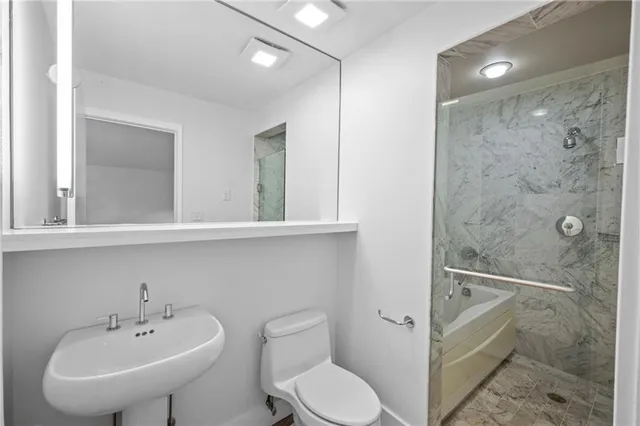 a bathroom with a sink toilet and shower