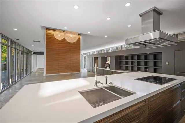 a kitchen with a sink and a stove top oven