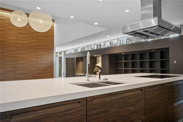 a kitchen with a sink and a large window