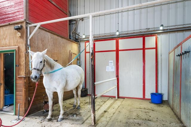 a view of a hallway with a table and chairs