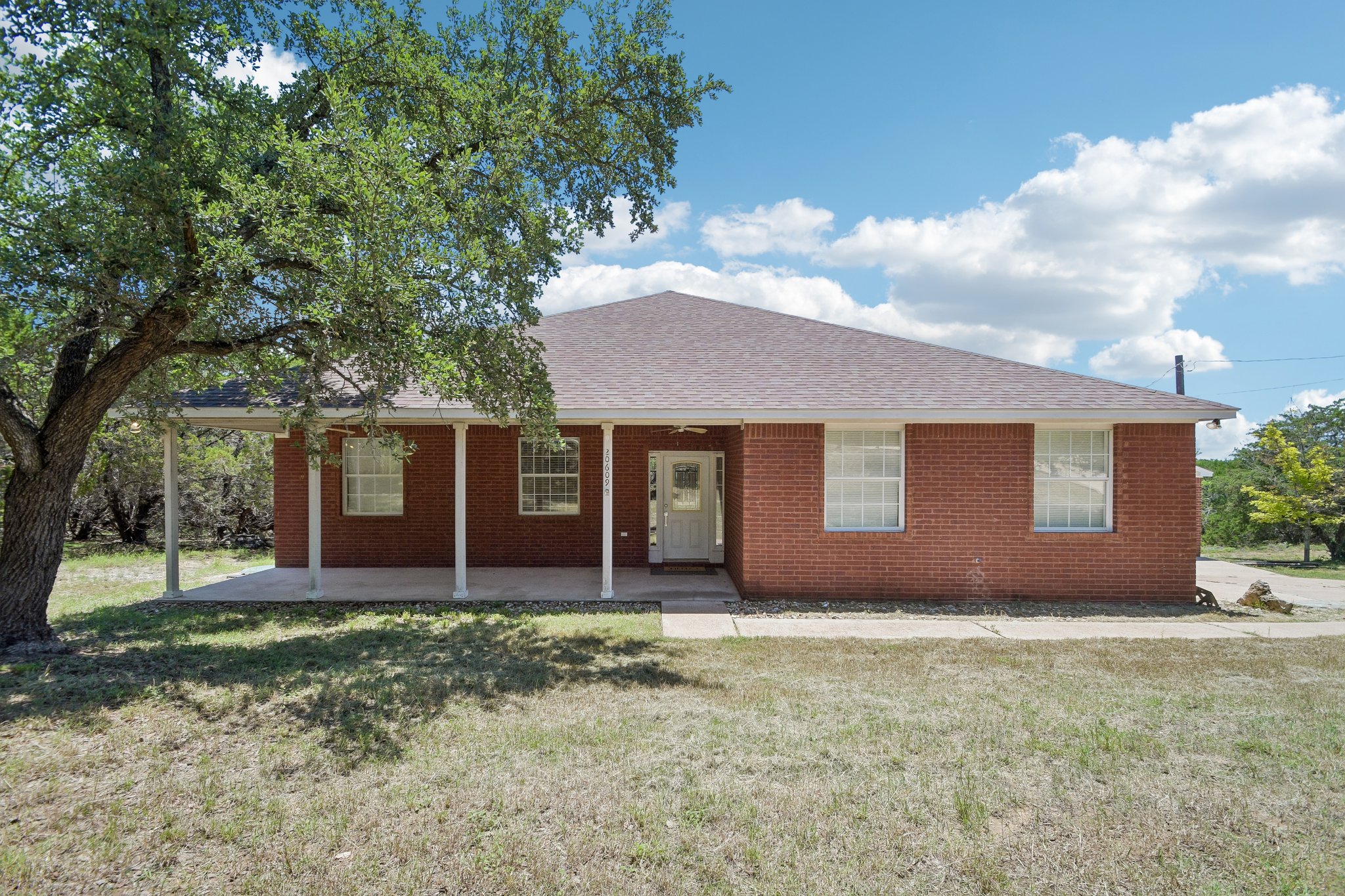 20609 Bridle Path Road Lago Vista, TX 78645 - Photo 6 of 30 A classic brick exterior with a welcoming covered front porch offers pleasant curb appeal.