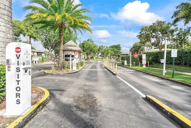 a view of a street with a cars park side of a road