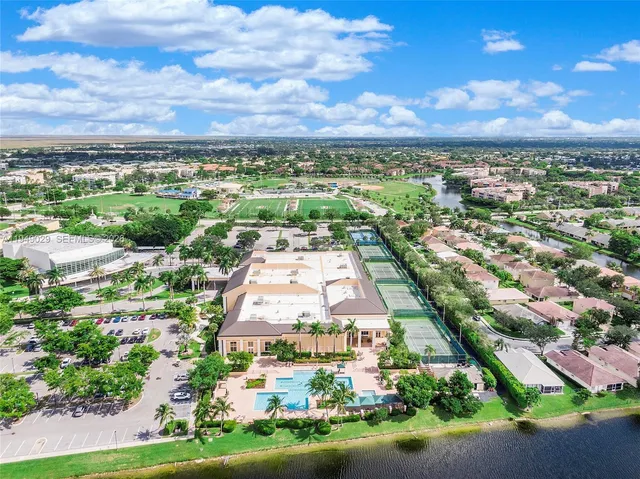 an aerial view of a city with lots of residential buildings and mountain view in back