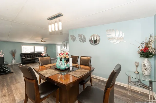 a view of a dining room with furniture and a chandelier