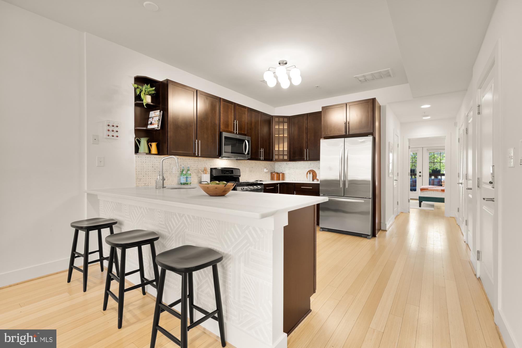 57 Bryant Street Northwest, Unit 2 Washington, DC 20001 - Photo 12 of 36 a kitchen with kitchen island a counter top space a sink appliances and cabinets