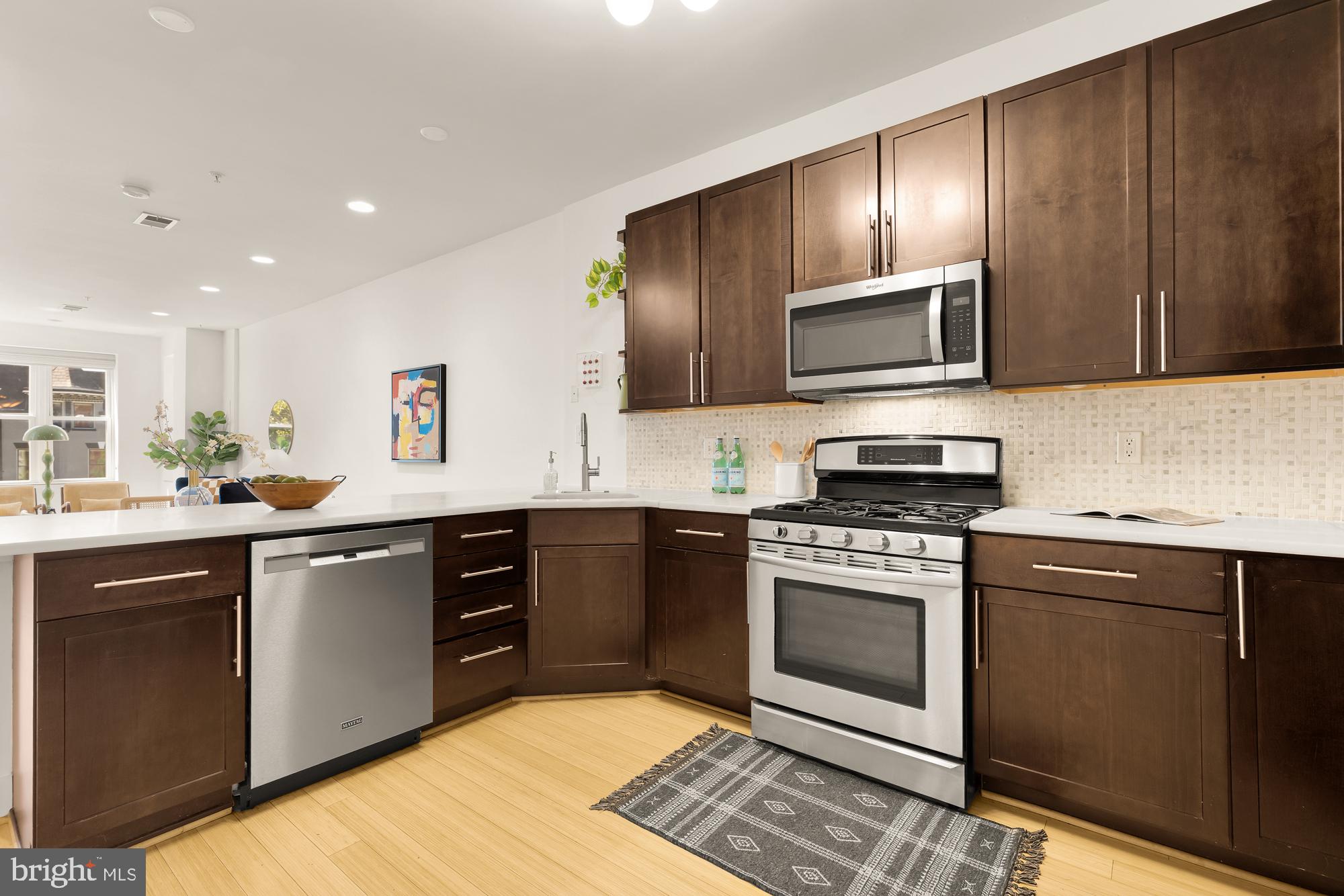 57 Bryant Street Northwest, Unit 2 Washington, DC 20001 - Photo 13 of 36 a kitchen with stainless steel appliances granite countertop wooden cabinets a stove top oven a sink and dishwasher