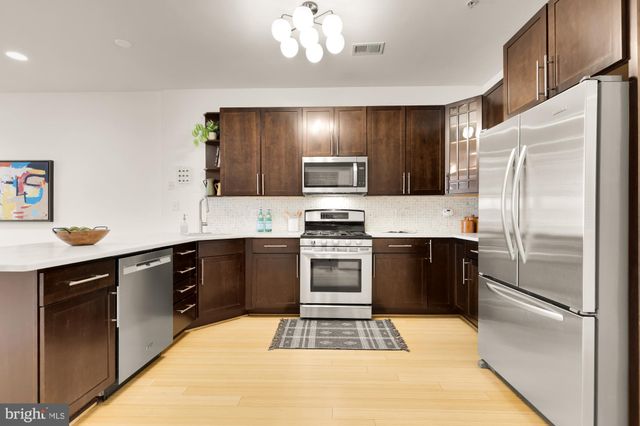 a kitchen with a refrigerator stove and sink