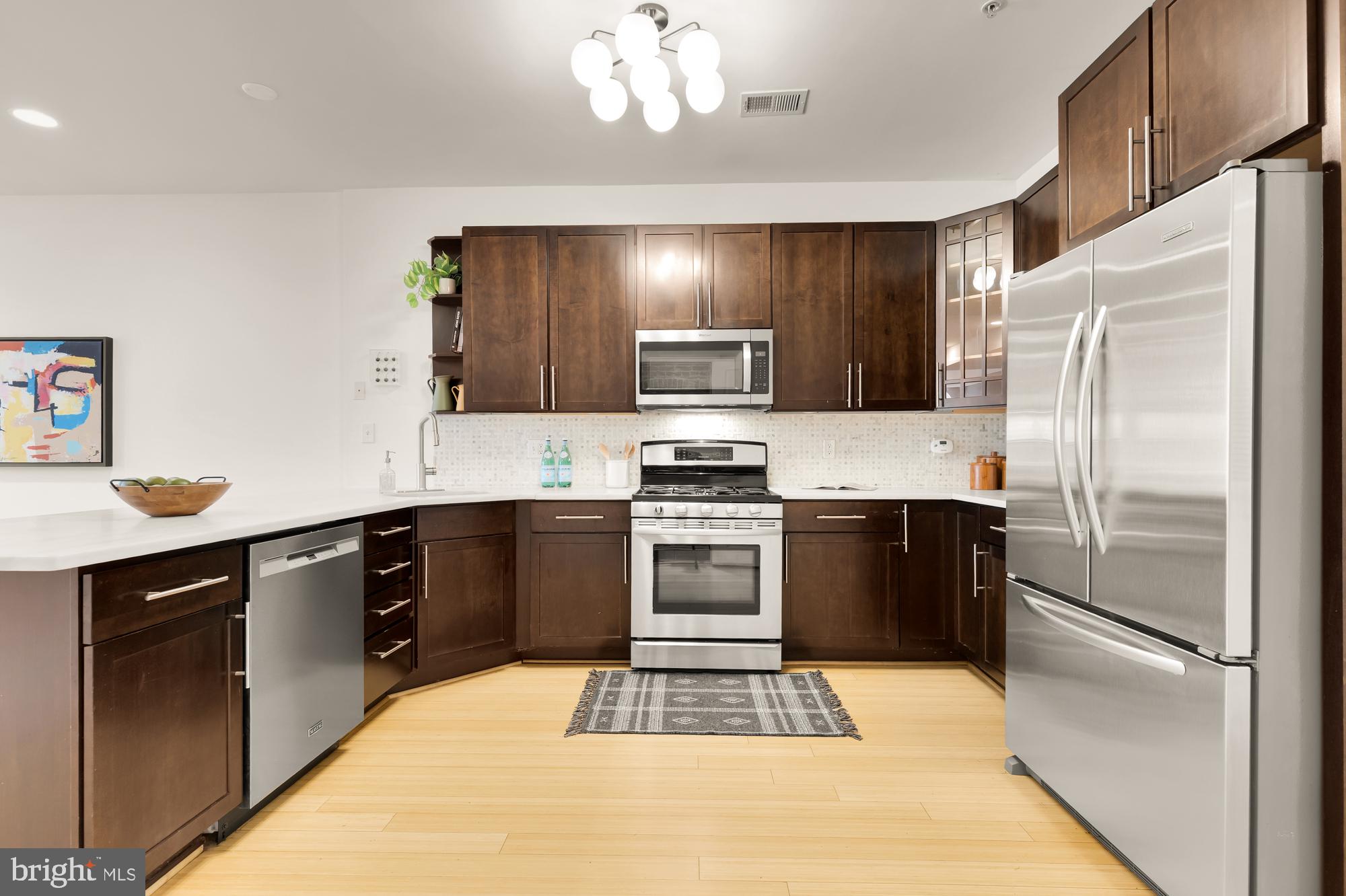 57 Bryant Street Northwest, Unit 2 Washington, DC 20001 - Photo 14 of 36 a kitchen with a refrigerator stove and sink