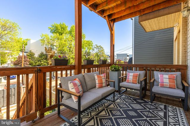 a roof deck with outdoor seating