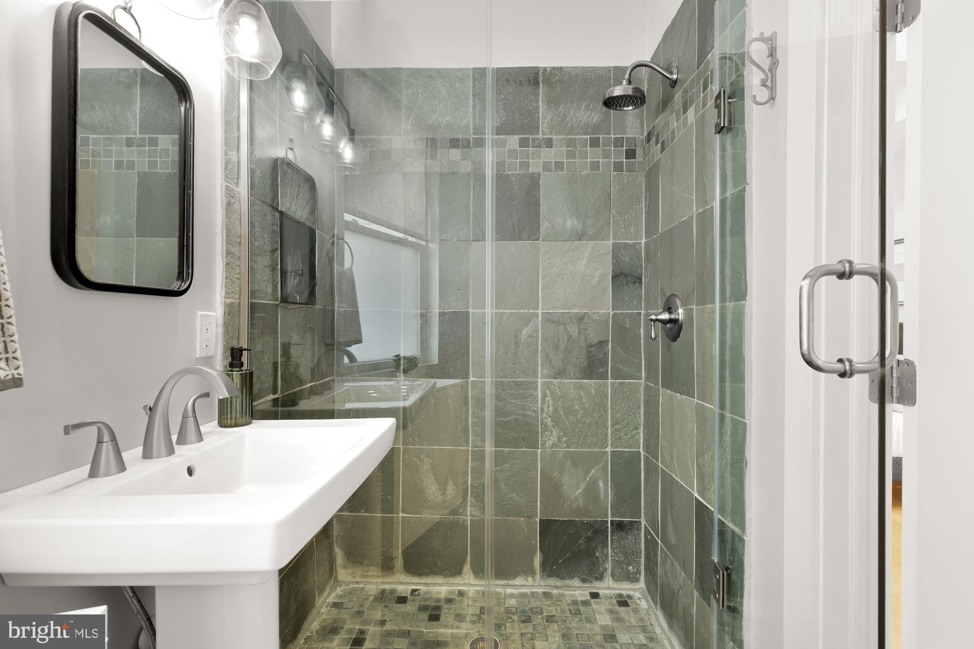 57 Bryant Street Northwest, Unit 2 Washington, DC 20001 - Photo 21 of 36 a bathroom with a sink shower and a mirror