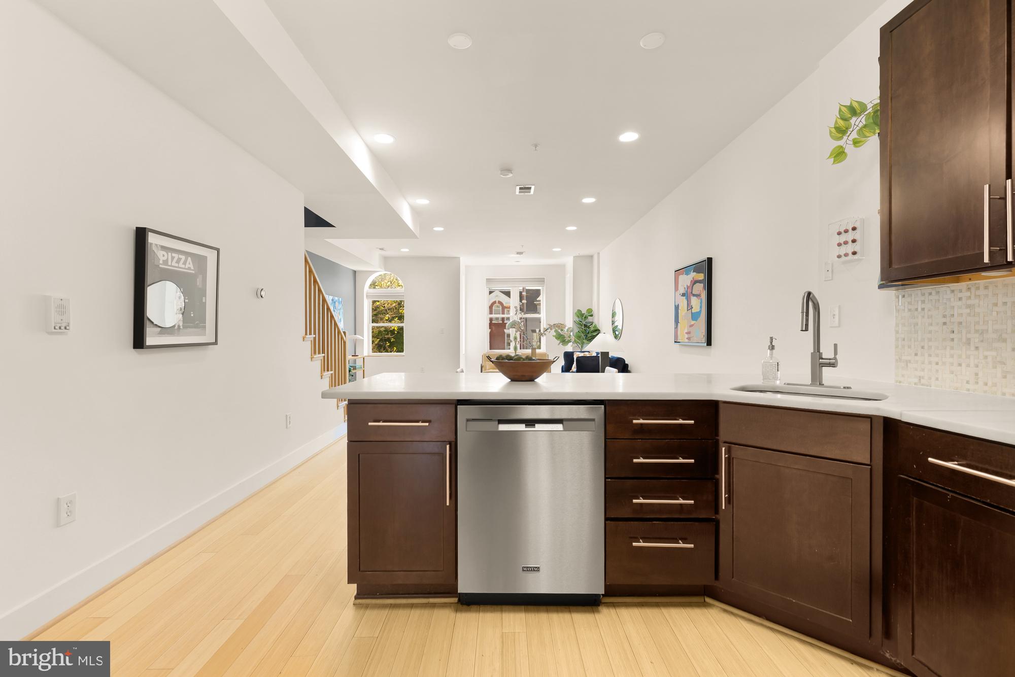 57 Bryant Street Northwest, Unit 2 Washington, DC 20001 - Photo 22 of 36 a kitchen with stainless steel appliances granite countertop a sink and cabinets