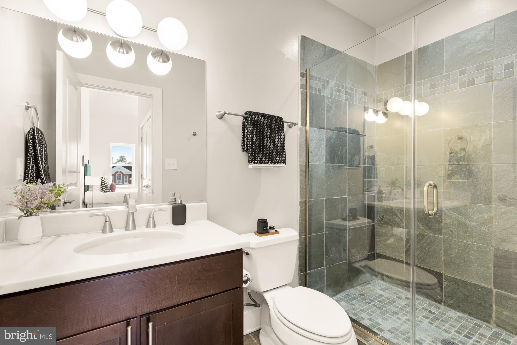 57 Bryant Street Northwest, Unit 2 Washington, DC 20001 - Photo 28 of 36 a bathroom with a sink a toilet and shower