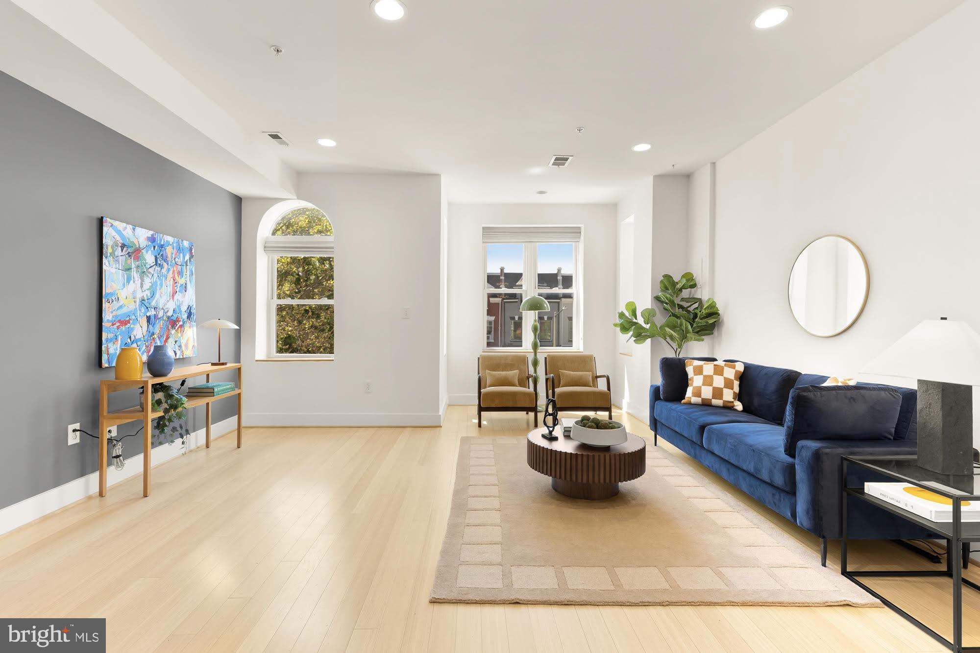 57 Bryant Street Northwest, Unit 2 Washington, DC 20001 - Photo 3 of 36 a living room with furniture and a large window