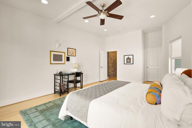a bedroom with a bed and ceiling fan