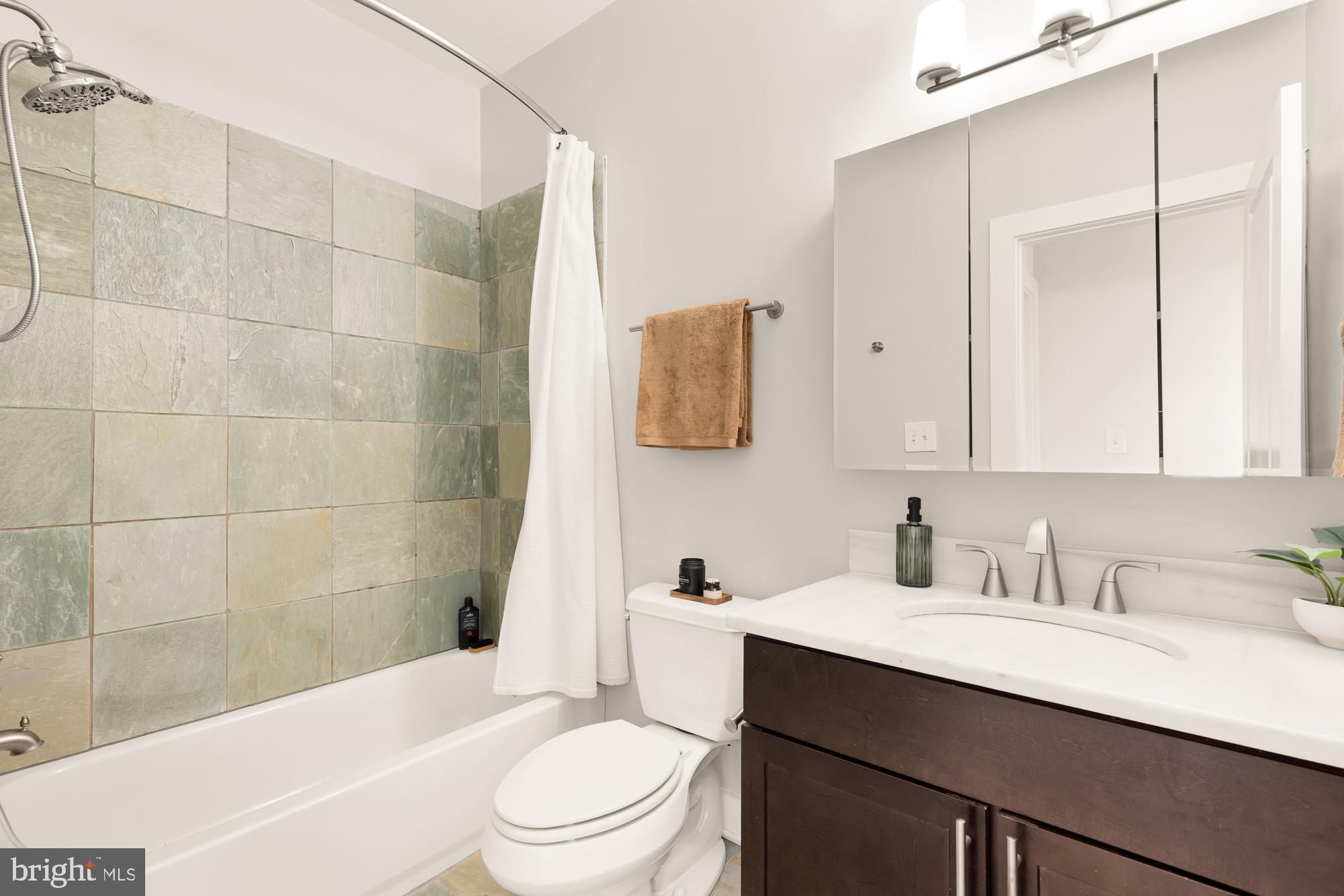 57 Bryant Street Northwest, Unit 2 Washington, DC 20001 - Photo 34 of 36 a bathroom with a sink a toilet and bathtub