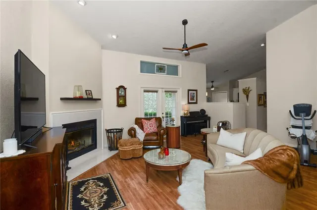 a living room with furniture a fireplace and a flat screen tv