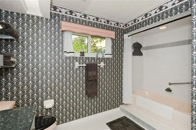 a bathroom with a bathtub and shower