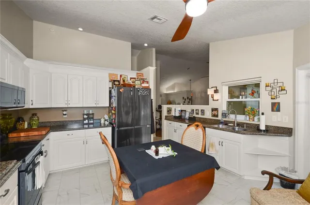 a kitchen with a sink appliances and cabinets
