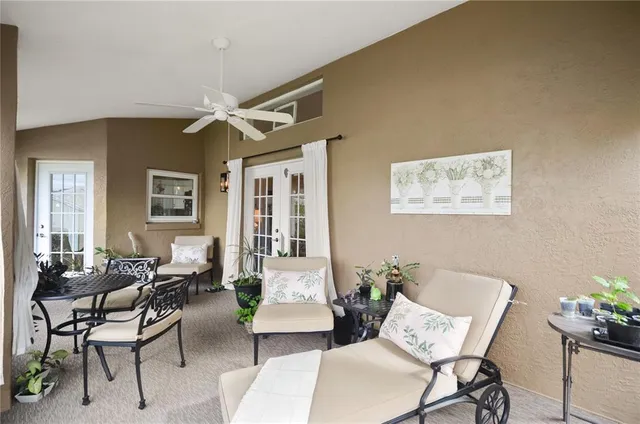 a living room with furniture and a potted plant