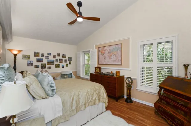 a bedroom with a bed next to a window with a bookshelf