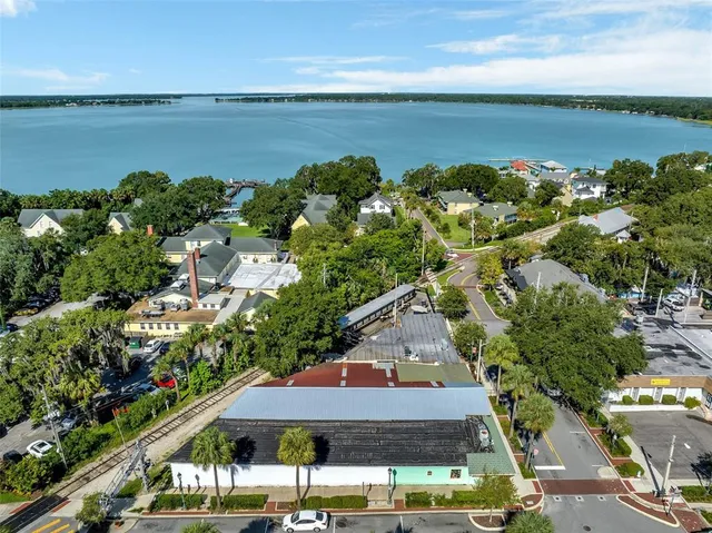an aerial view of a house with a garden and lake view